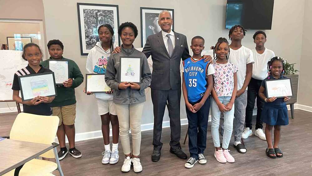 SPHA's President and CEO Mr. Michael Lundy with young artists at The Legacy at Jordan Park.