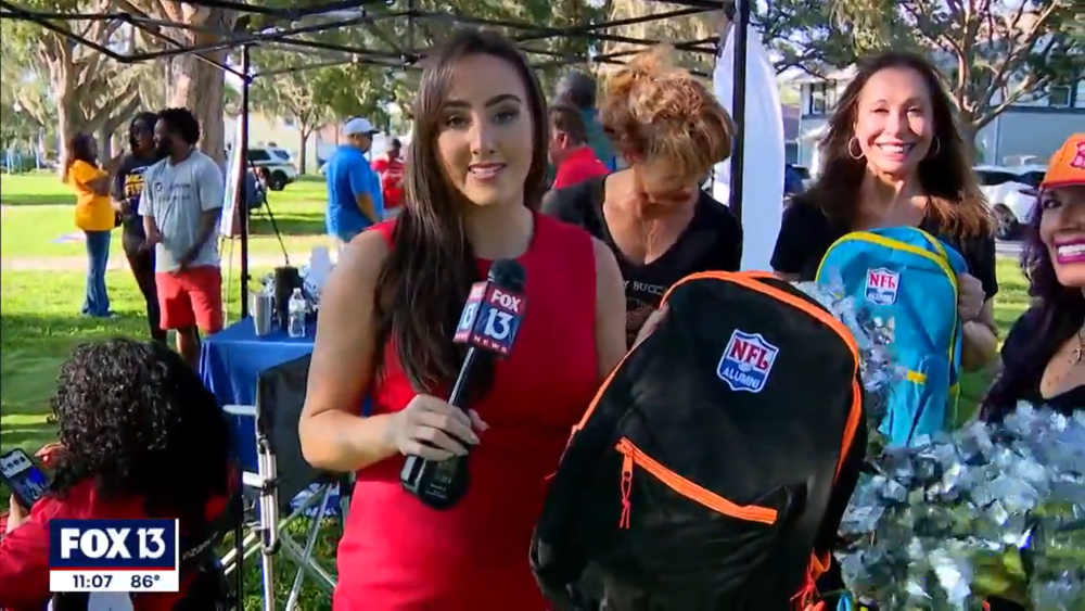 Image of FOX 13 News reporter at Jordan Park Back to School event.