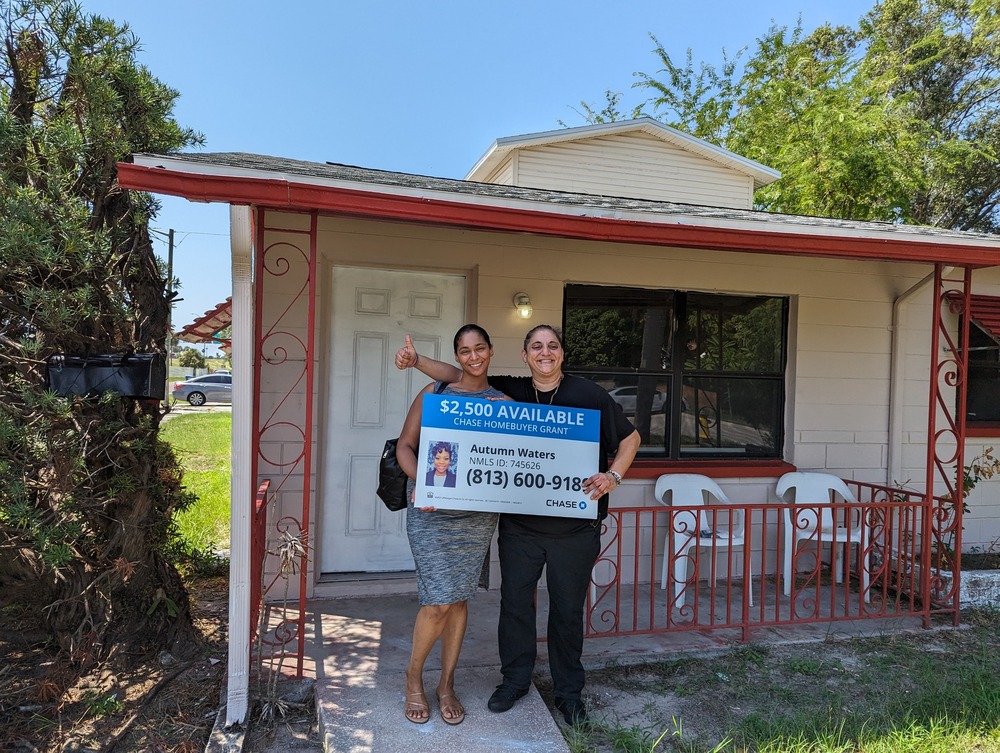 FSS Participant and daughter in front of their new home.