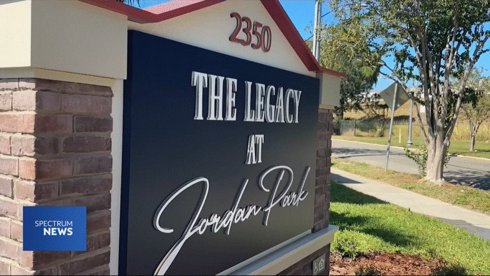 Entrance sign for The Legacy at Jordan Park midrise building in St. Petersburg.