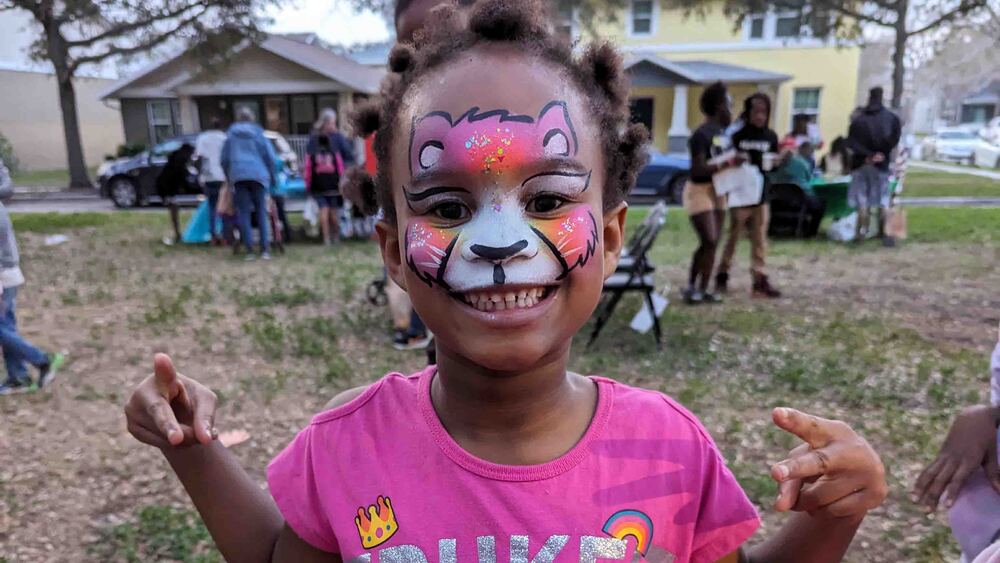 Girl with face painted at Very Merry Holiday Party 2023.