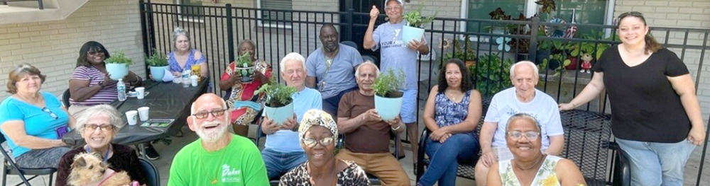 Group of St. Petersburg Housing Authority residents smiling.