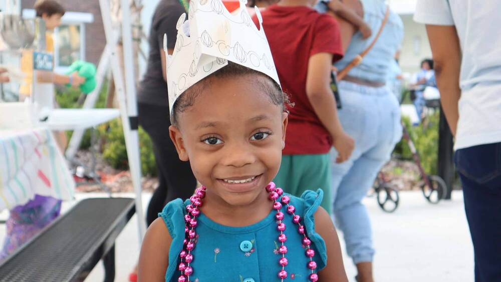 Child smiling at Winter Wonderland event at The Legacy at Jordan Park.