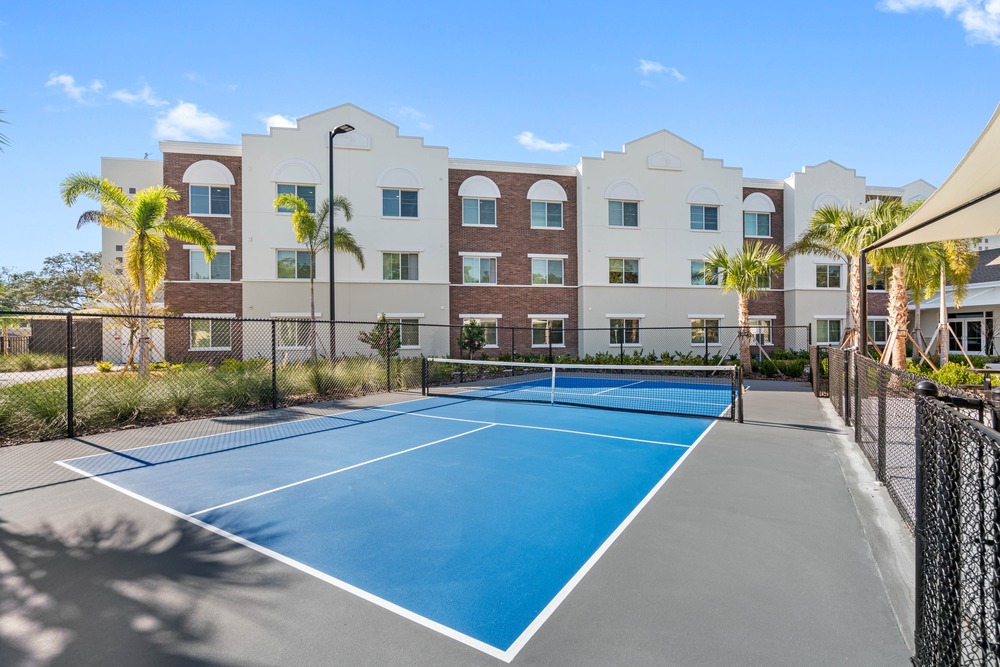 Pickleball court with The Legacy at Jordan Park building in the background.