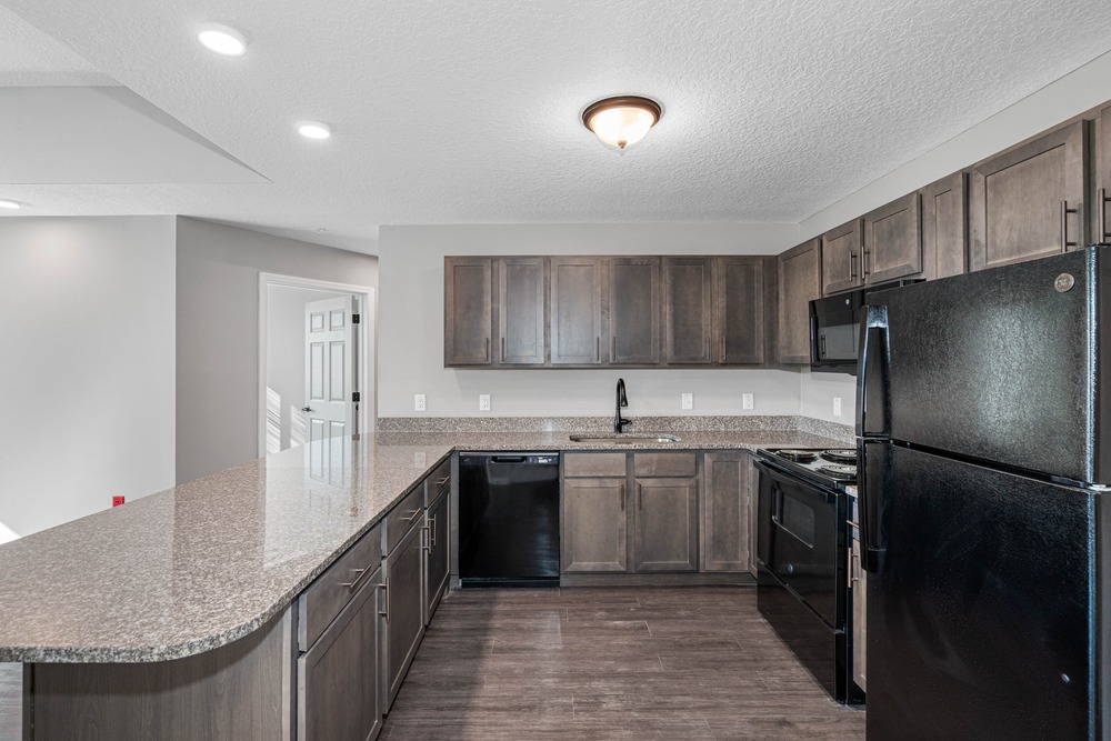 Unit kitchen inside The Legacy at Jordan Park senior midrise building.