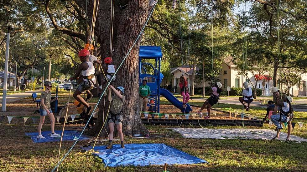 Kids participating in tree climb at Jordan Park.