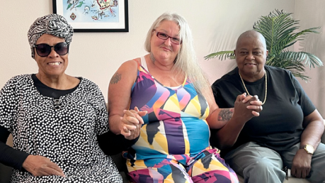 Three residents of The Legacy at Jordan Park sitting.