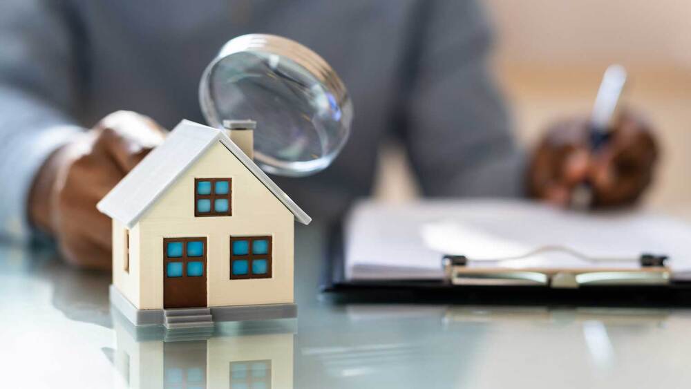 House inspection with magnifying glass.