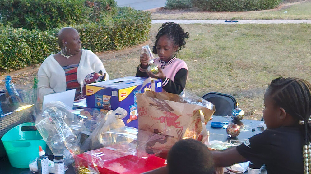 Families crafting holiday ornaments at Disston Place Apartments.