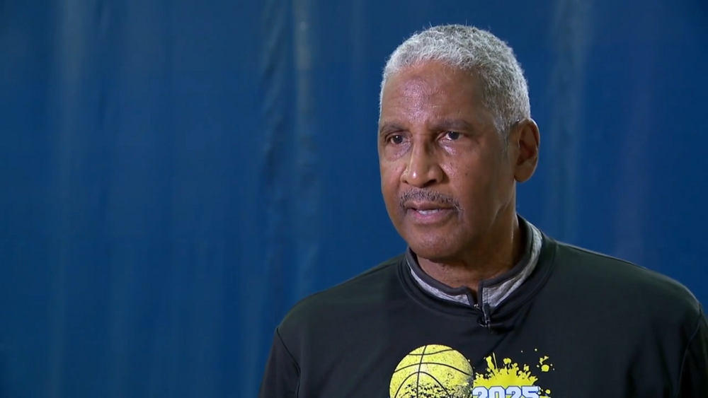 President and CEO of SPHA, Michael Lundy talking at basketball court.