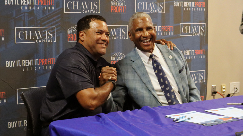 Michael Lundy, President & CEO of the St. Petersburg Housing Authority and Bryan Chavis, Founder of Buy It Rent It PROFIT Education™, shaking hands.