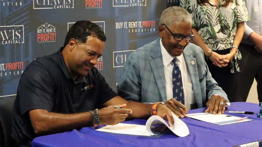 Ceremonial signing of a Memorandum of Understanding (MOU) between Mr. Lundy and Mr. Chavis.