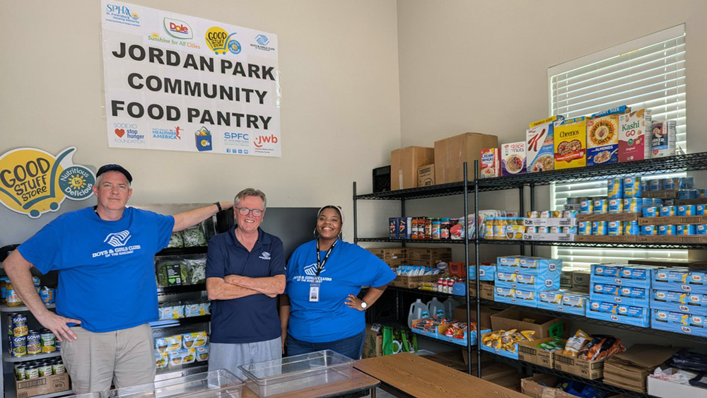 Three Boys & Girls Clubs of the Suncoast team members in the Jordan Park Community Food Pantry.
