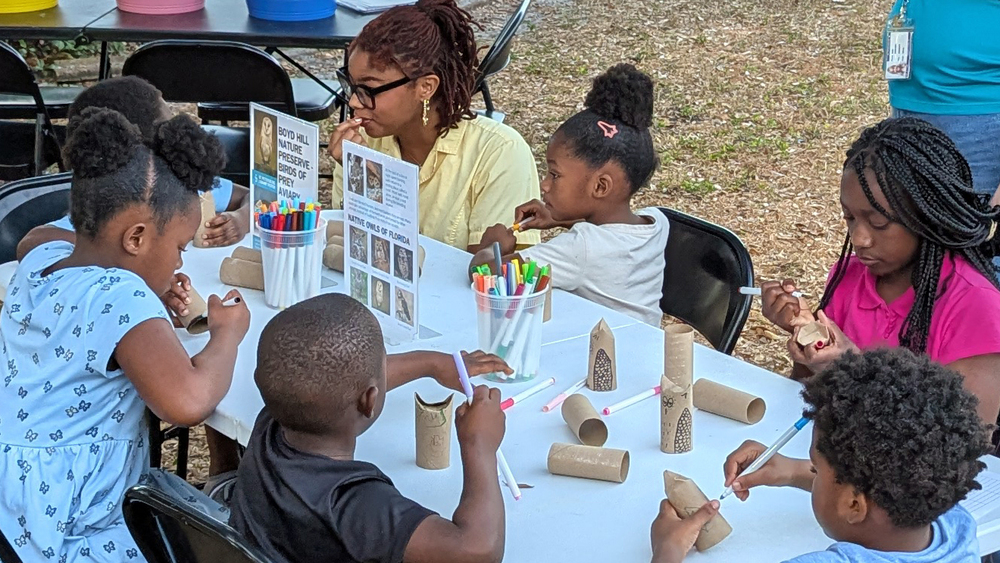 Families at Disston Place Apartments participating in crafting activity.