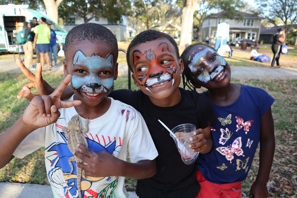 Three children enjoying activities at the SPHA Spring Family Picnic in Jordan Park.
