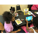 Three kids using mobile learning lab tablets.