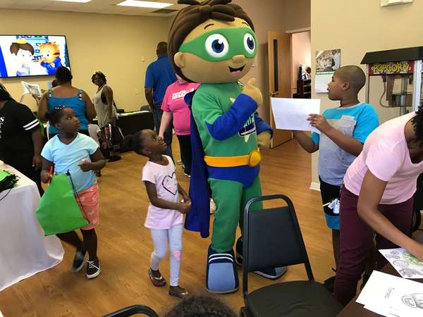 Wyatt Beanstalk from Super Why speaking with a group of children