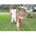 Family standing on green grass at Family Fun Day event in Crescent Lake Park.
