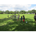 Kids lining up on grass for game.