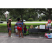 Group of people standing in front of soda cooler.