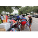Backpacks and snacks on tables with families getting items from tables.