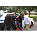 Policeman giving a tour of his police car to children at Gateway Place Apartments.