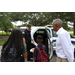 Policeman giving a tour of his police car to children with SPHA President and CEO Michael Lundy standing near the car.
