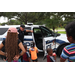 Policeman giving a tour of his police car to children and parents.