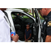 Child standing near police car door.
