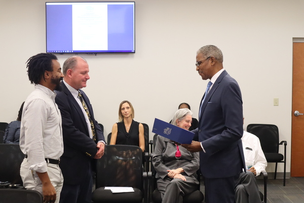 Derek Keys, Meiko Seymour, and SPHA President and CEO Michael Lundy standing at St. Petersburg Housing Authority (SPHA) main office.