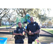 Two St. Petersburg Police officers smiling at Very Merry Holiday Party at Jordan Park.