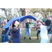 Children and adults playing in grass area at Very Merry Holiday Party at Jordan Park.