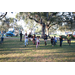 Children running in grass area at Very Merry Holiday Party at Jordan Park.