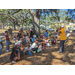 Families sitting under tree at Jordan Park Easter Egg Hunt.