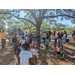 Families standing under tree at Jordan Park Easter Egg Hunt.