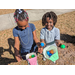 Two children with plastic eggs at Jordan Park Easter Egg Hunt.