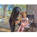 Child having her face painted while sitting at Jordan Park.