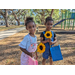 Children with sunflowers at Jordan Park Easter Egg Hunt.