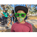 Child with green sunglasses and face paint.