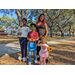 Family holding flowers at Jordan Park Easter Egg Hunt.