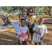 Family smiling with flowers at Jordan Park Easter Egg Hunt.