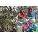 Kids climbing a tree and people eating watermelon.