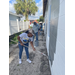 SPHA team members painting house.