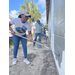 SPHA team members painting house.