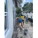 SPHA team members painting house.