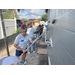 SPHA team members painting house.