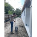 SPHA team members painting house.