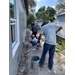 Michael Lundy, President and CEO of the St. Petersburg Housing Authority, painting a Habitat for Humanity house with SPHA team.
