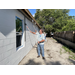 SPHA team members painting house.