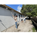 SPHA team members painting house.